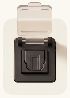 A square Toslink optical socket with its hinged clear dust flap propped open